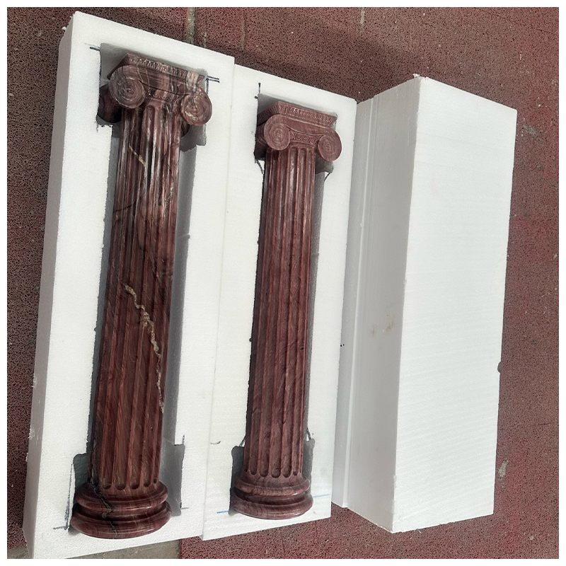 Four Carved Exotic Red Quartzite Fluted Ionic Columns