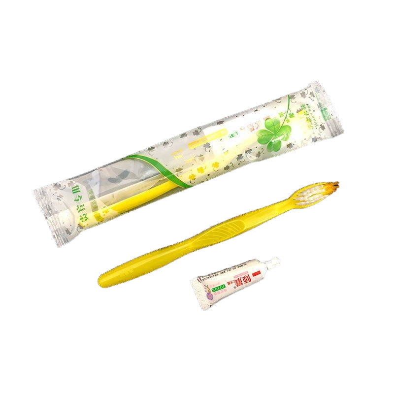 Toothbrush and Toothpaste in Plastic Packing with Hotel Amenities for Guest Room