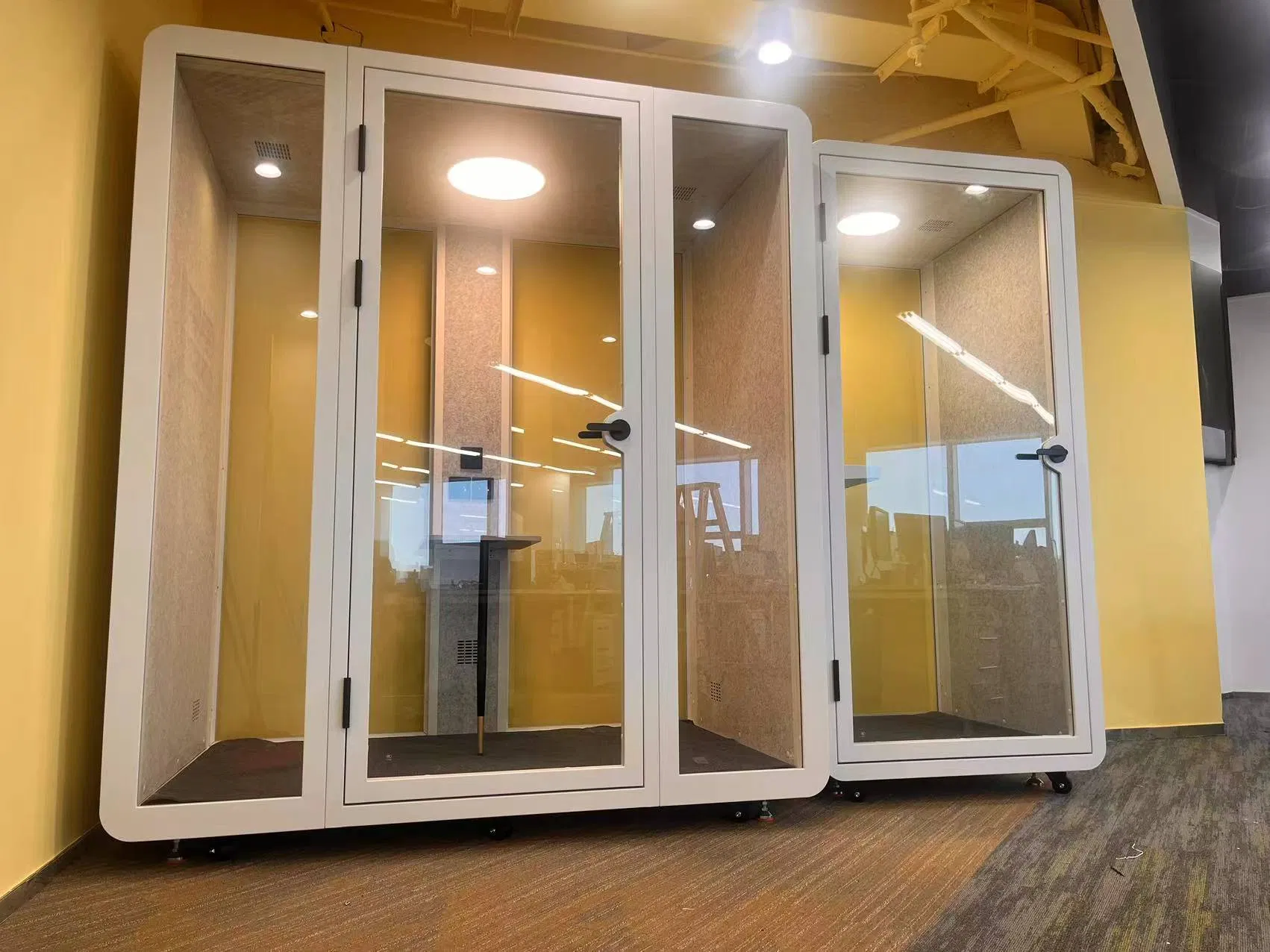 a Log Cabin with Electronic Decoration for a Telephone Booth and a Phone Booth