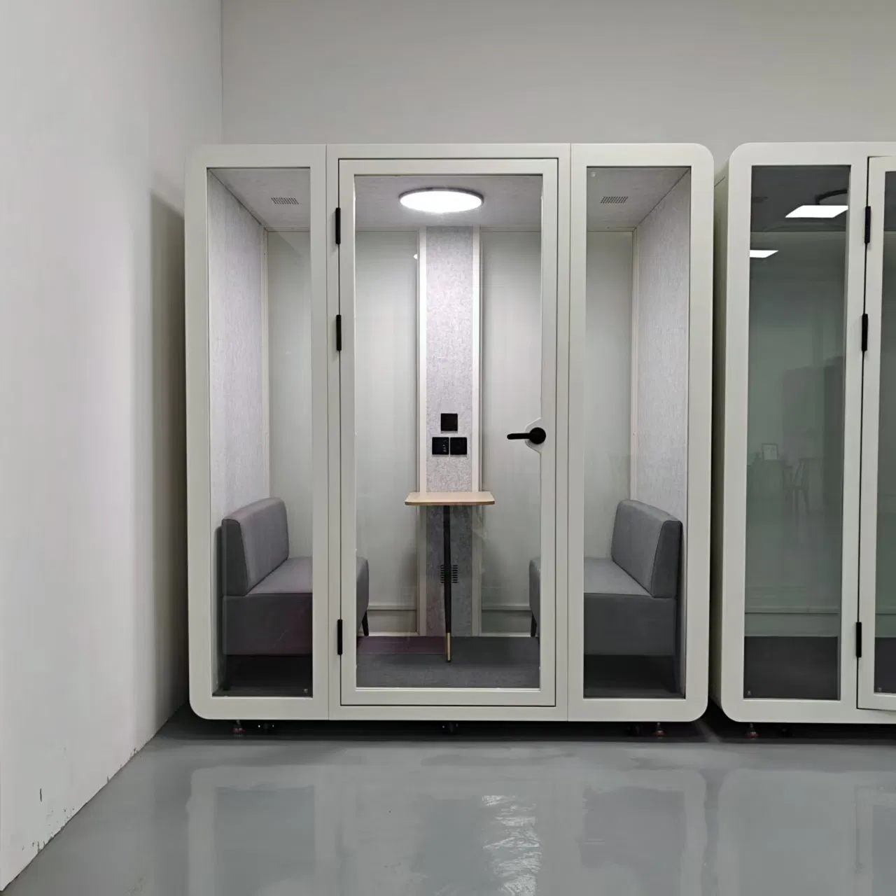 a Telephone Booth and Phone Booth Next to a Meeting Pod Serve as a Quiet Work Pod