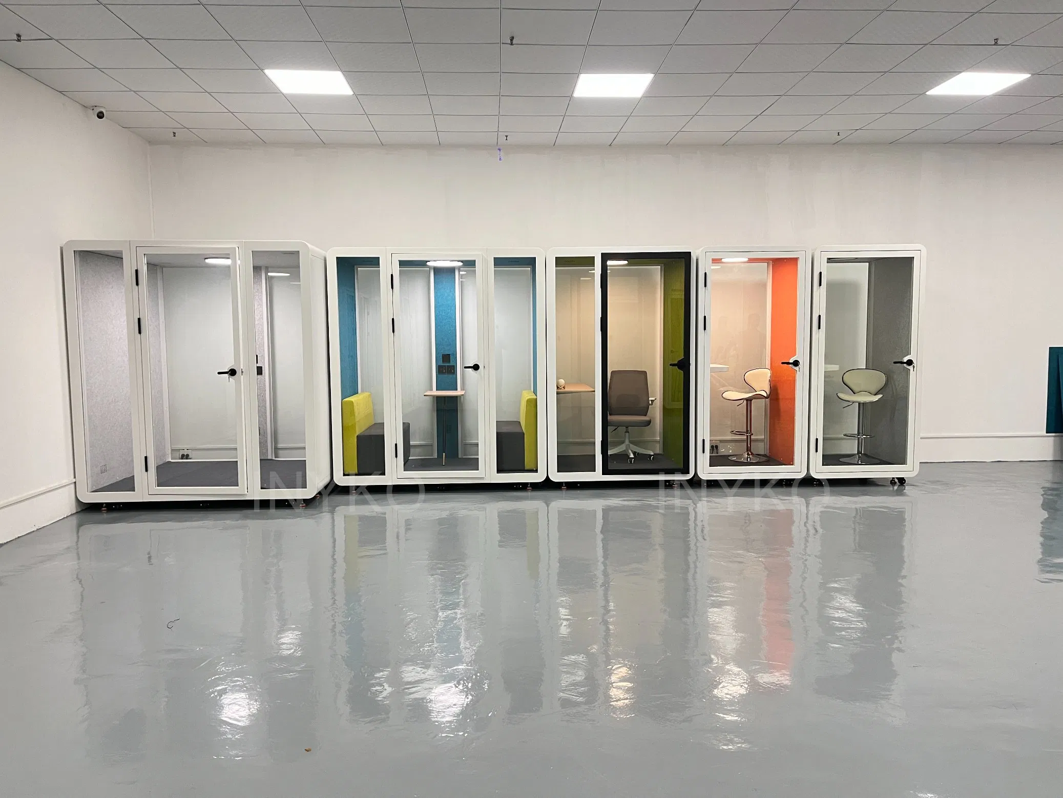 a Log Cabin with Electronic Decoration for a Telephone Booth and a Phone Booth