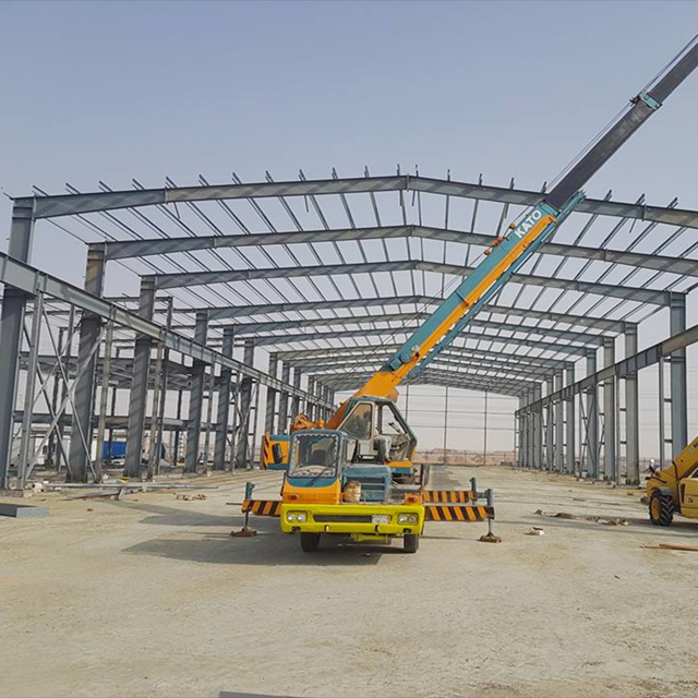 Design H Section Galvanized Metal Construction Prefab/Prefabricated Frame Industrial Building Workshop/Warehouse Steel Structure with Painted Sandwich Panel