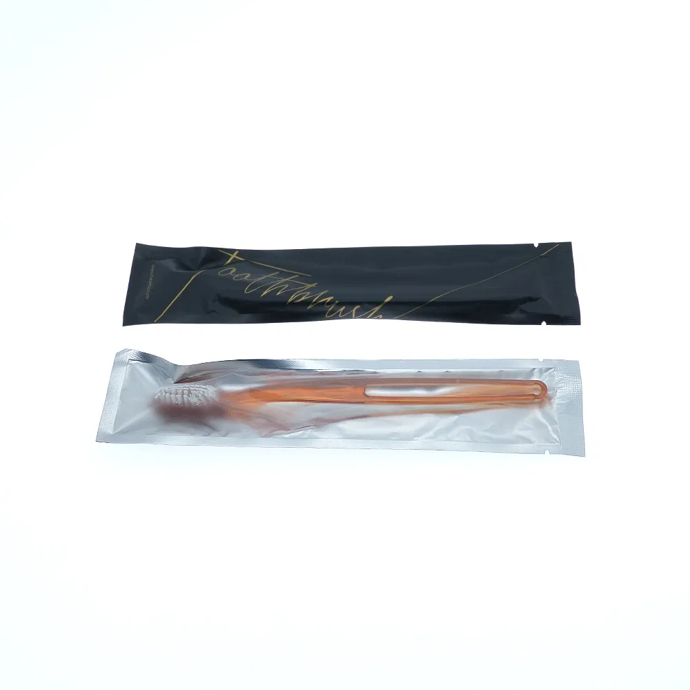 Toothbrush and Toothpaste in Plastic Packing with Hotel Amenities for Guest Room