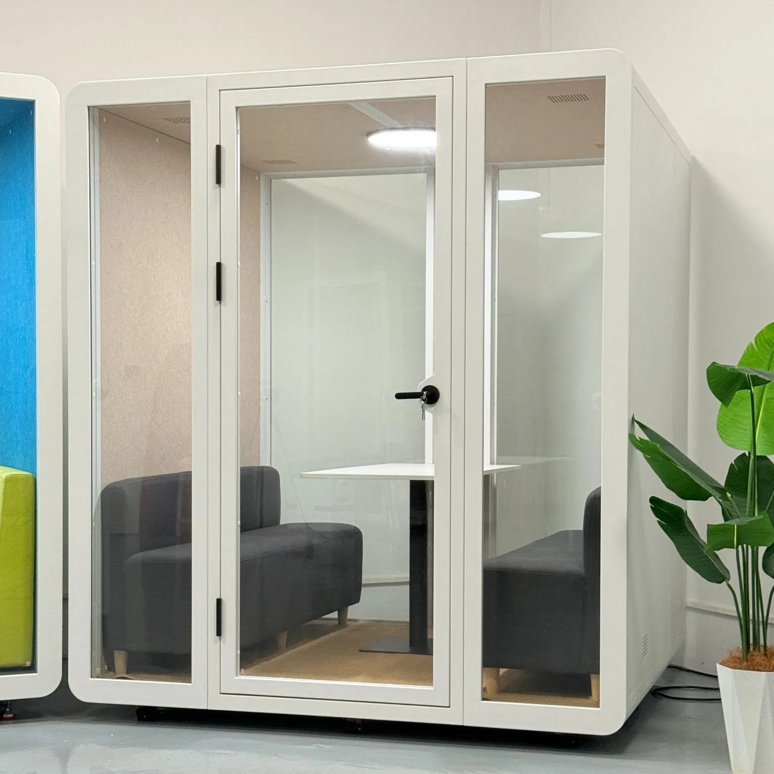 a Telephone Booth and Phone Booth Next to a Meeting Pod Serve as a Quiet Work Pod