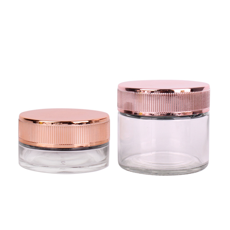 Hot Sell 50ml 150ml Empty Clear Cylinder Glass Face Cream Storage Jar with Golden Plating Child Proof Resistant Cap for Sale