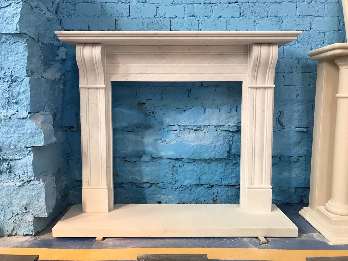 China Wholesale Interior Decoration Modern Style Hand Made Carved Artificial Stone Marble Fireplace Mantel Design Price