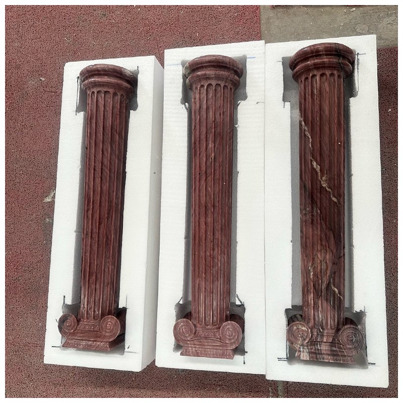 Four Carved Exotic Red Quartzite Fluted Ionic Columns