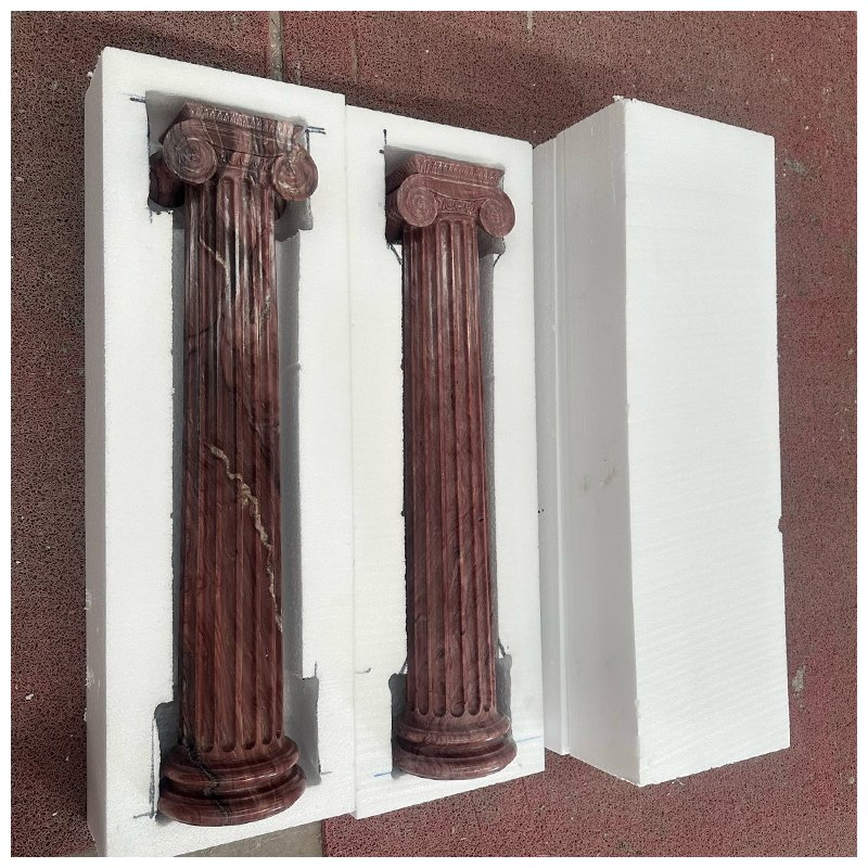Four Carved Exotic Red Quartzite Fluted Ionic Columns